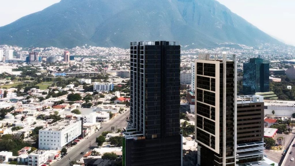Aerial View of a City Center with Tall Skyscrapers and a Mountain in the Background. - Capitanes Regios