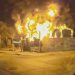 Incendio En Santa Catarina Nl - Capitanes Regios Nighttime Street View of a Building Engulfed in Flames with Thick Smoke Above the Fence. - Capitanes Regios