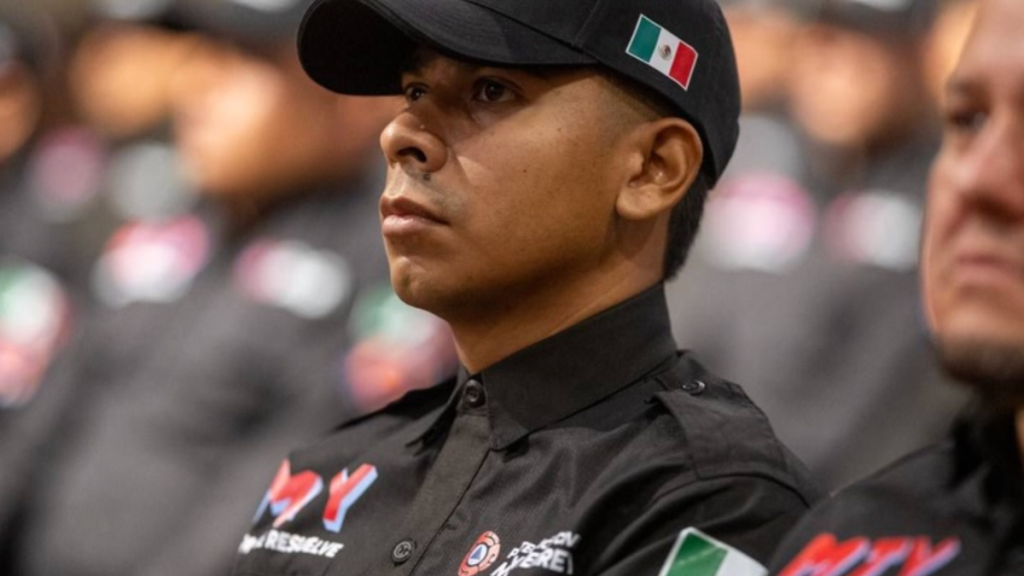 Young Man in a Black Uniform with a Mexican Flag Patch on His Cap, Attending a Formal Ceremony and Looking Attentive. - Capitanes Regios
