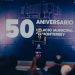 Man at a Podium Delivering a Speech in Front of a Large Banner Reading '50 Aniversario' and 'gobierno De Monterrey'. - Capitanes Regios