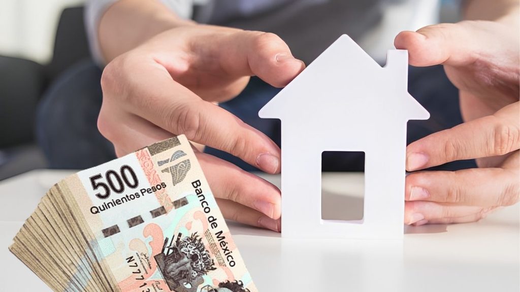Hands Cradle a White House Model Beside a Fan of 500 Pesos, Symbolizing Home Financing in Mexico or a Mortgage. - Capitanes Regios