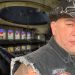 Capitanes-regios-carlos-trejojpg - Capitanes Regios Man Wearing a Studded Black Cowboy Hat and a Sleeveless Denim Vest Stands in a Dilapidated Church with Colorful Stained-glass Windows in the Background. - Capitanes Regios